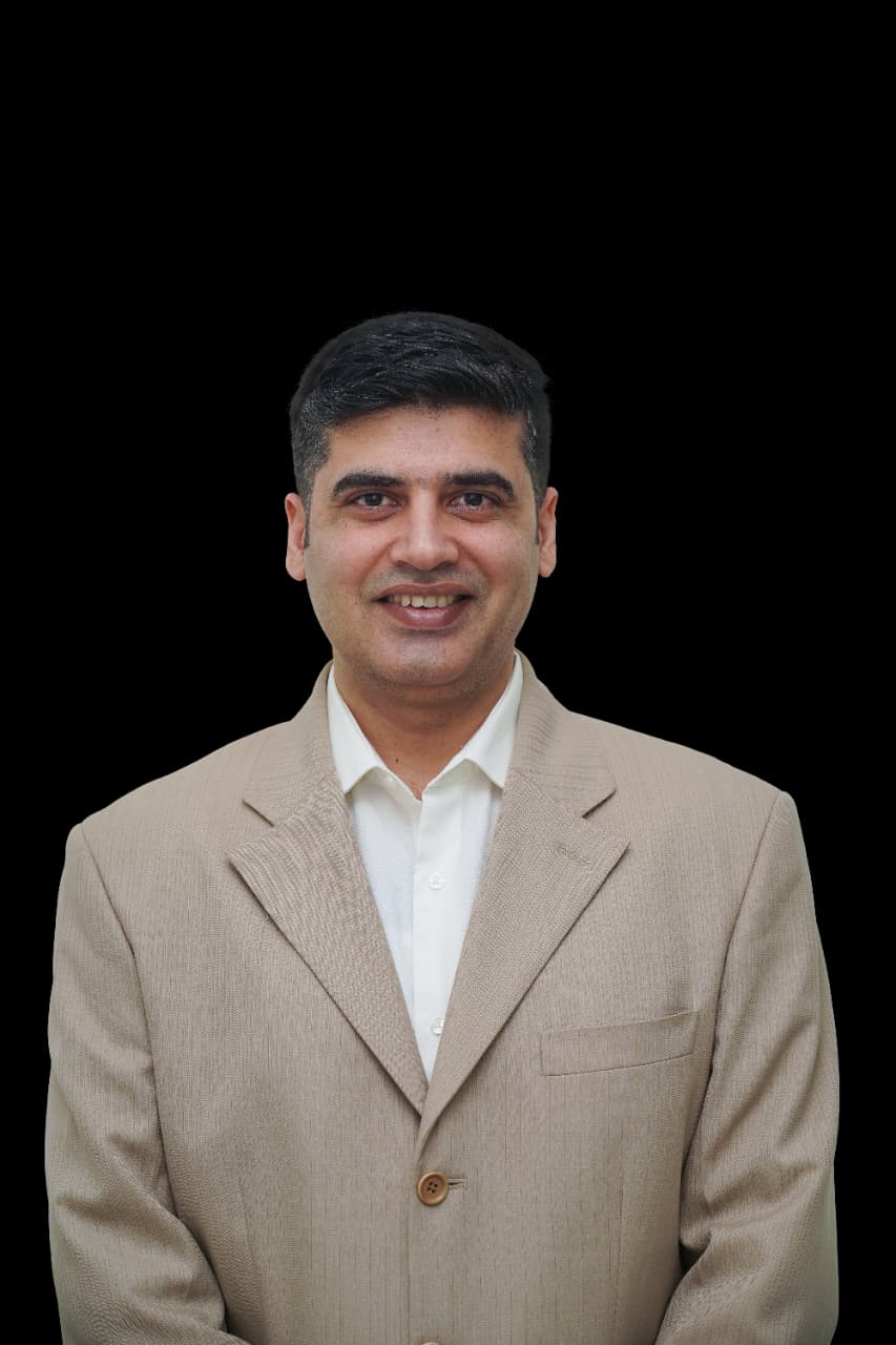 Dr. Manpreet Singh wearing a beige jacket